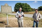 Christian County farmers John and Alexander Young stand in front of the historical marker where Harry Young planted his first commercial crop of no-till corn